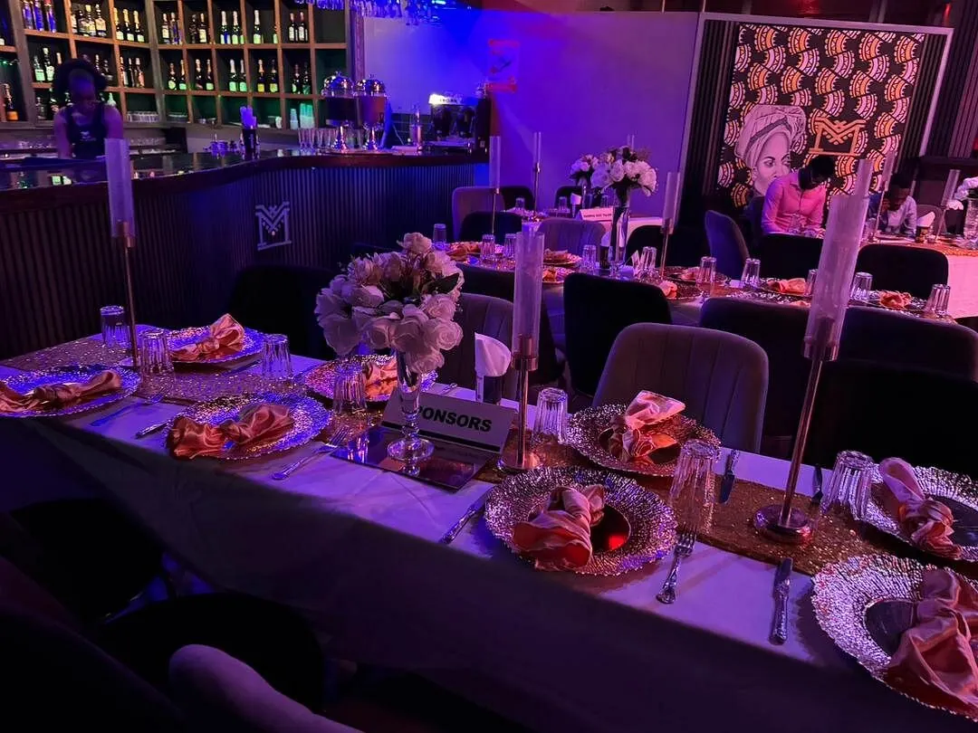Long tables dressed for a seated gala dinner