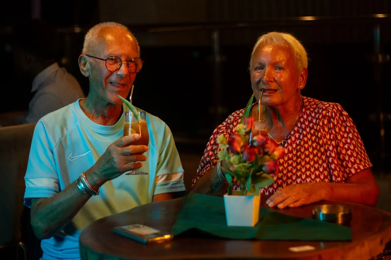 A couple over cocktails at their table in the dining room