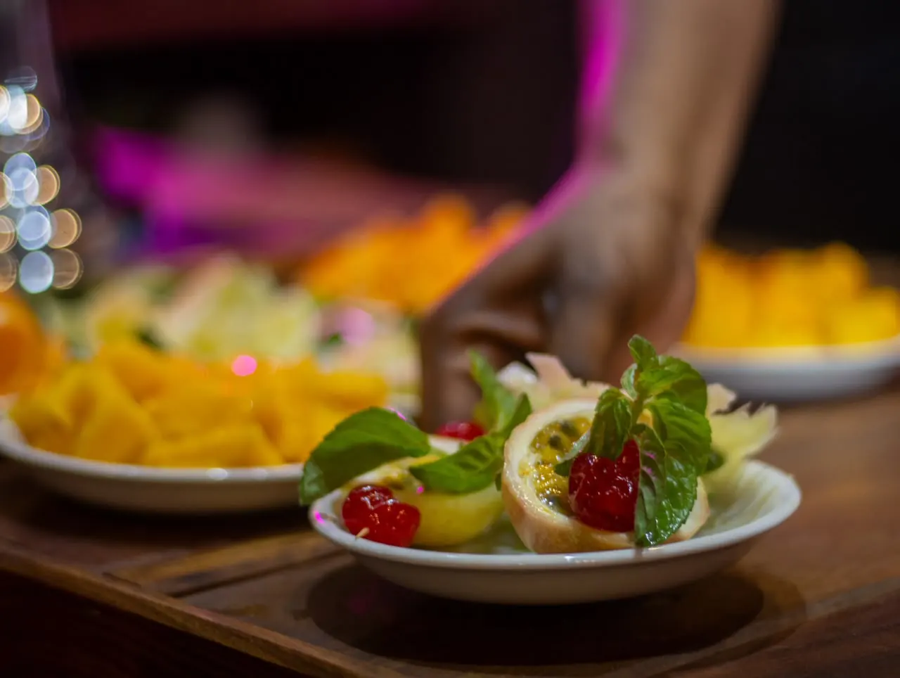 A fresh fruit plate dressed with passion fruit, cherries and mint